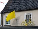 Yellow Flag And Bicycle On A House In Southwold Stock Photo