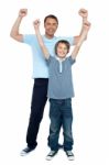 Father And Son Rejoicing Together Stock Photo