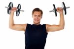 Smiling Athlete With Dumbbells Stock Photo