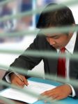 Businessman Reading A Document Stock Photo