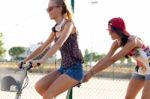 Group Of Friends With Roller Skates And Bike Riding In The Park Stock Photo