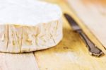 Camembert Cheese And Vintage Knife On Wooden Table Stock Photo