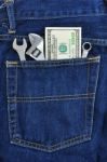 Several Tools And Dollar Banknote In Pocket Stock Photo