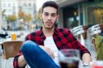 Handsome Man Looking At Camera At Coffee Shop Stock Photo