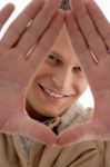 Smiling Man Showing Hand Gesture Stock Photo