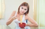 Young Girl Eating Ramen Noodles Stock Photo