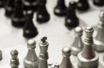 Light And Dark Wooden Chess Pieces On Chess Table Stock Photo