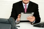 Cropped Image Of Businessman Using Tablet Pc Stock Photo