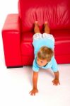 Boy On Red Sofa Stock Photo