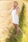 Lonely Beautiful Young Blonde Girl In White Dress With Straw Hat Stock Photo