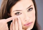 Woman Putting Contact Lens Stock Photo