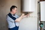 Worker Tightens The Screws With A Wrench Stock Photo