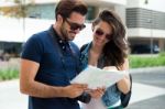 Young Tourist Couple In Town Holding A Map Stock Photo