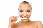 Smiling Woman Brushing Her Teeth Stock Photo