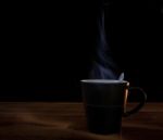 Black Cup Of Hot Coffee On Wood Texture With Dark Background Stock Photo