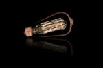 Incandescent Light Bulb On Black Background Stock Photo