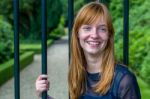 Redhead Girl Laughing Holding Bar Gate Stock Photo