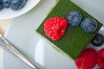 Green Tea Matcha Mousse Cake With Berries Stock Photo