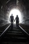 Couple Walking Together Through A Railway Tunnel Stock Photo