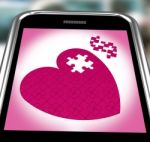 Puzzle Heart On Smartphone Showing Commitment Stock Photo