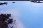 Milky White And Blue Water Between The Lava Stones Covered With Moss Stock Photo