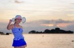 Girl On The Beach At Sunrise Over The Sea Stock Photo