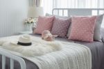 Pink Pillows With Pink Doll On White Wooden Bed And Classic Hat Stock Photo