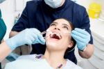 Female Patient Under Dental Treatment Stock Photo