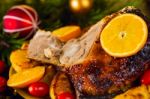 Christmas Baked Duck Served With Potatoes, Orange And Tomatoes Stock Photo