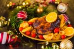 Christmas Baked Duck Served With Potatoes, Orange And Tomatoes Stock Photo