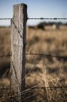 Rusted Sharp Timber And Metal Barb Wire Fence Stock Photo