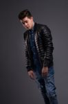 Casual Young Man In Black Leather Jacket And Denim Jeans Stock Photo