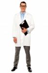 Smiling Doctor Holding Clipboard Stock Photo