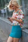 Woman In The Street Browsing A Smart Phone Stock Photo