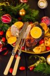 Christmas Baked Duck Served With Potatoes, Orange And Tomatoes Stock Photo