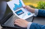 Handsome Businessman Wearing Suit And Using Modern Laptop Outdoo Stock Photo