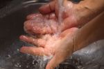 Hands Being Washed Under Stream Of Water Stock Photo