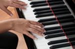 A Woman Playing Piano Stock Photo