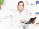 Woman In Bathrobe With Computer Stock Photo