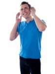 Smiling Young Male Listening Music Stock Photo