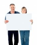 Aged Couple Holding Blank Board Stock Photo