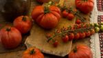 Freshly Picked Tomatoes, Place On Wooden Chopping Board And Table Stock Photo