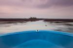 Small Boat In The Lake Of Red Lotus With Blur Background Stock Photo