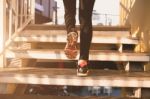 Close Up Of Feet With Sneakers Climbing Up The Stairs Stock Photo