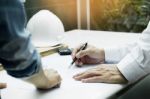 Architects Engineer Discussing At The Table With Blueprint - Clo Stock Photo