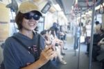 Face Of Woman In Sky Train With Smart Phone In Hand Stock Photo