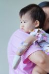 Mother Carrying Sick Baby In Hospital Stock Photo