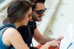 Young Tourist Couple In Town Holding A Map Stock Photo