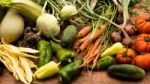 Several Vegetables On Wooden Chopping Board And Table Stock Photo