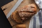 Dark Multigrain Bread Whole Grain Fresh Baked On Rustic Closeup Stock Photo